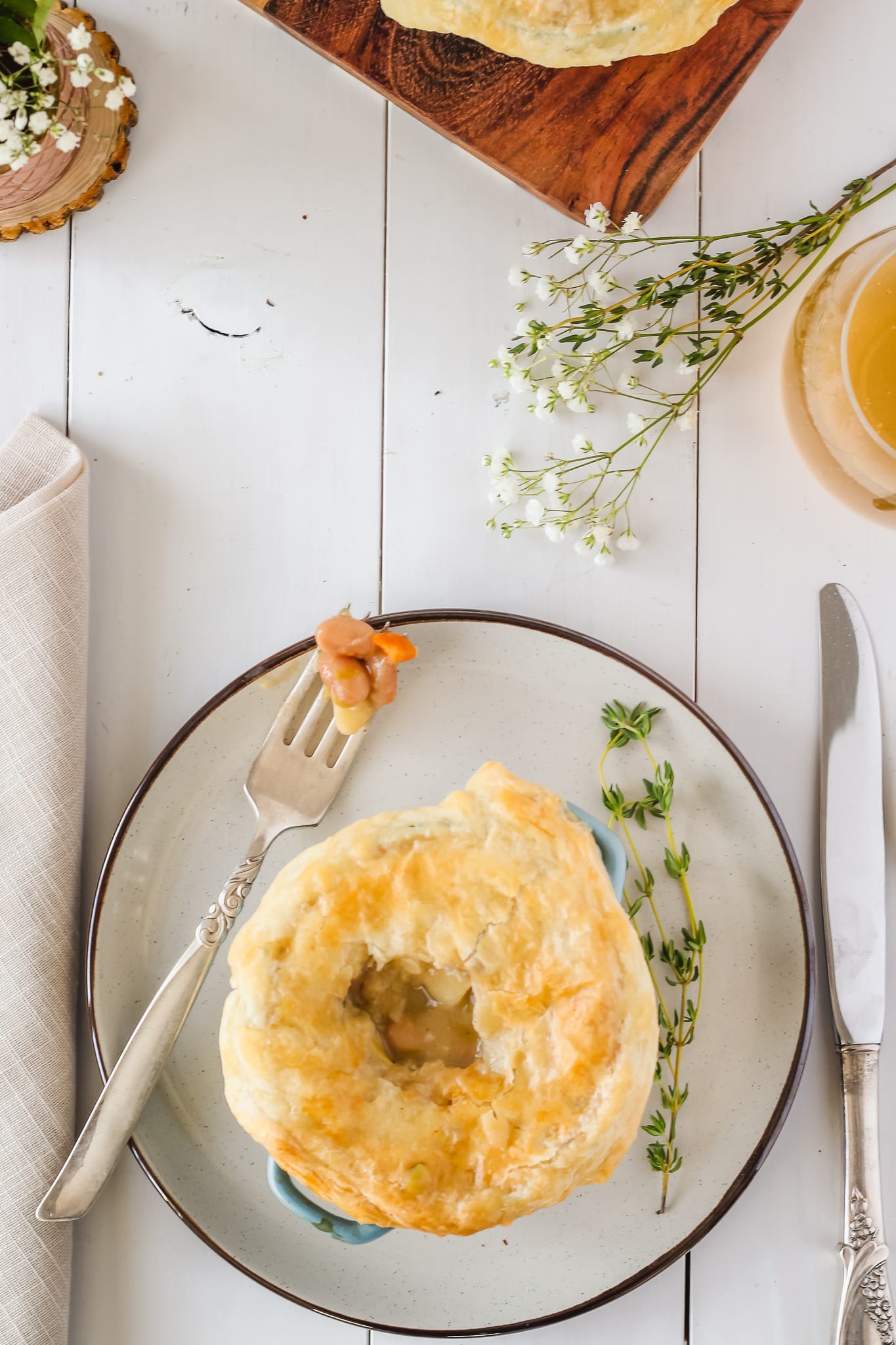 cooked pot pie on a plate with a forkful on the side