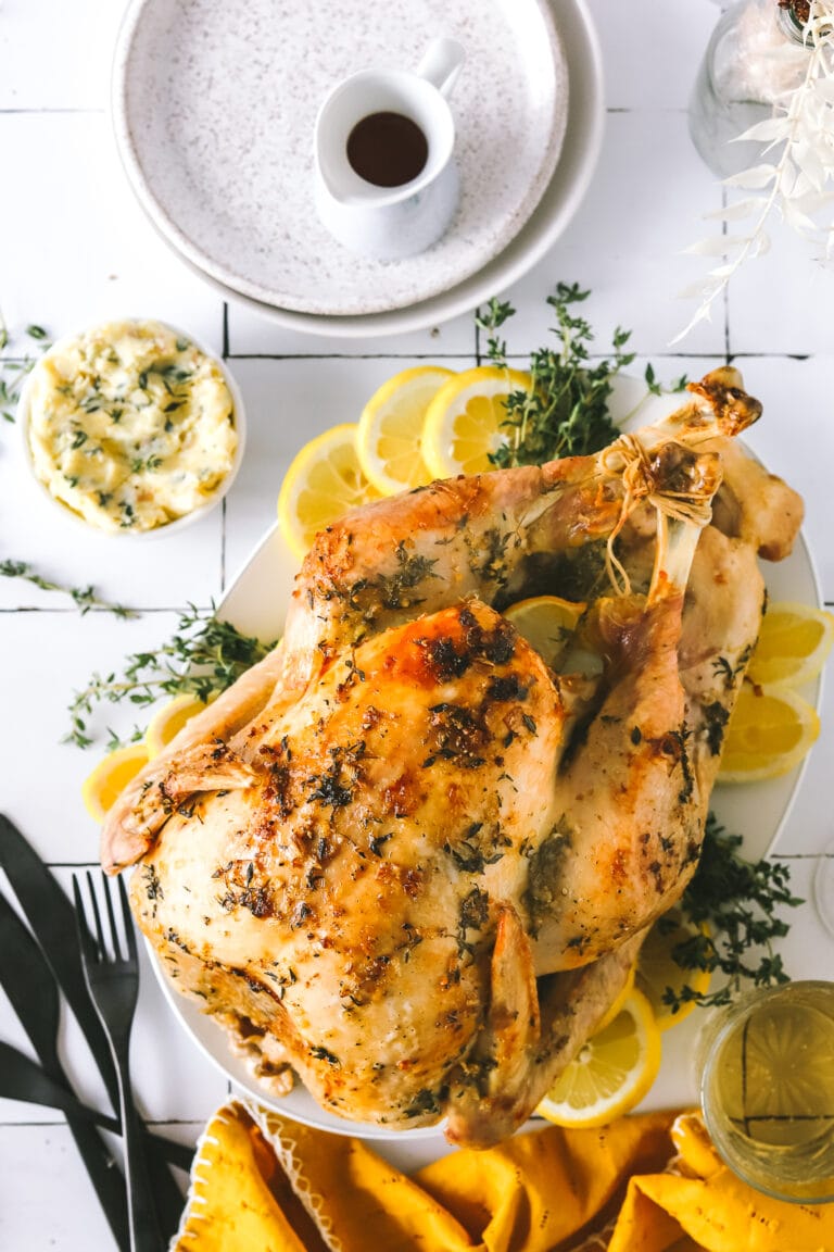 roasted turkey with lemon and herbs on a platter