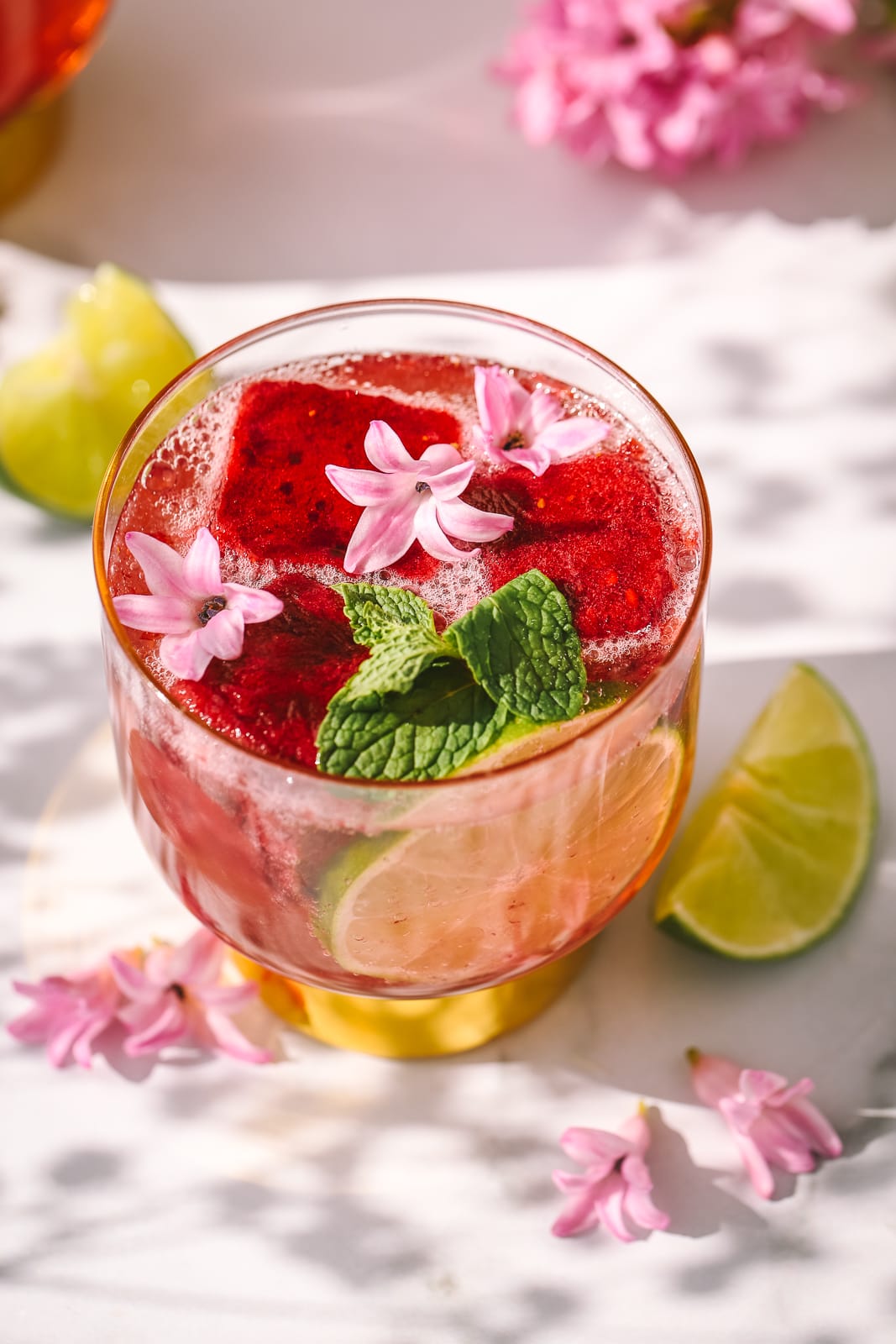 angled shot of a blackberry cocktail in a glass