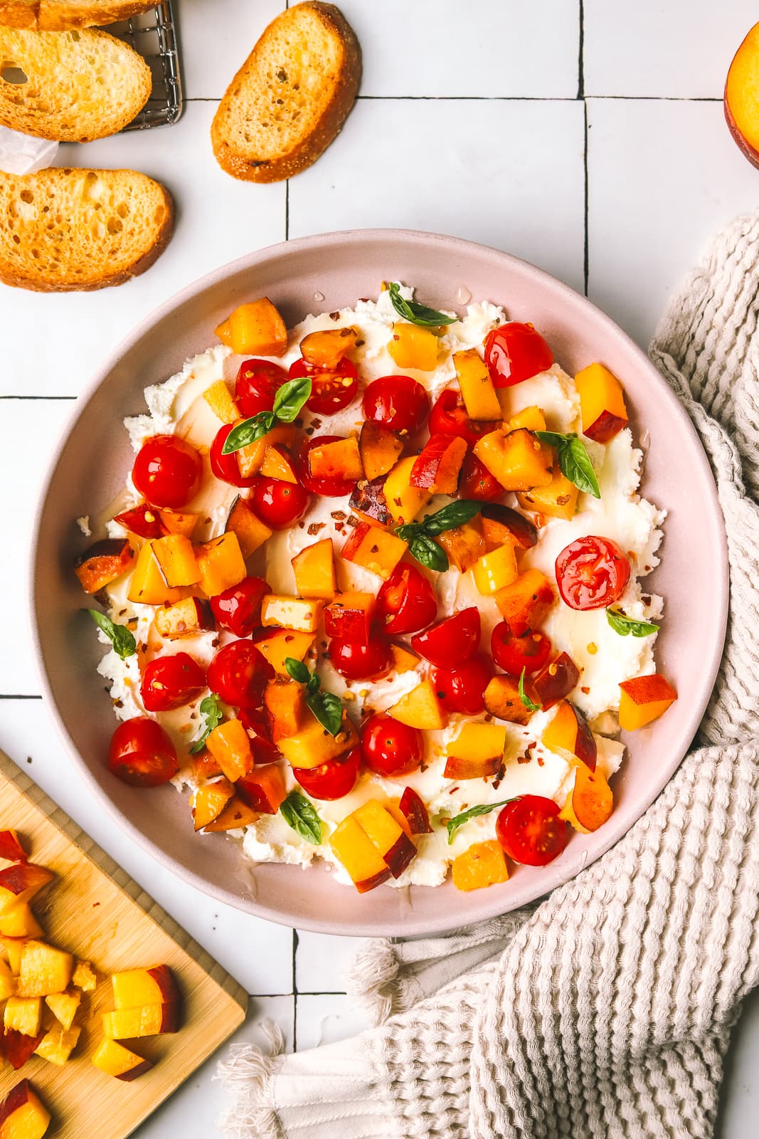 peaches and tomatoes with goat cheese served on crostini