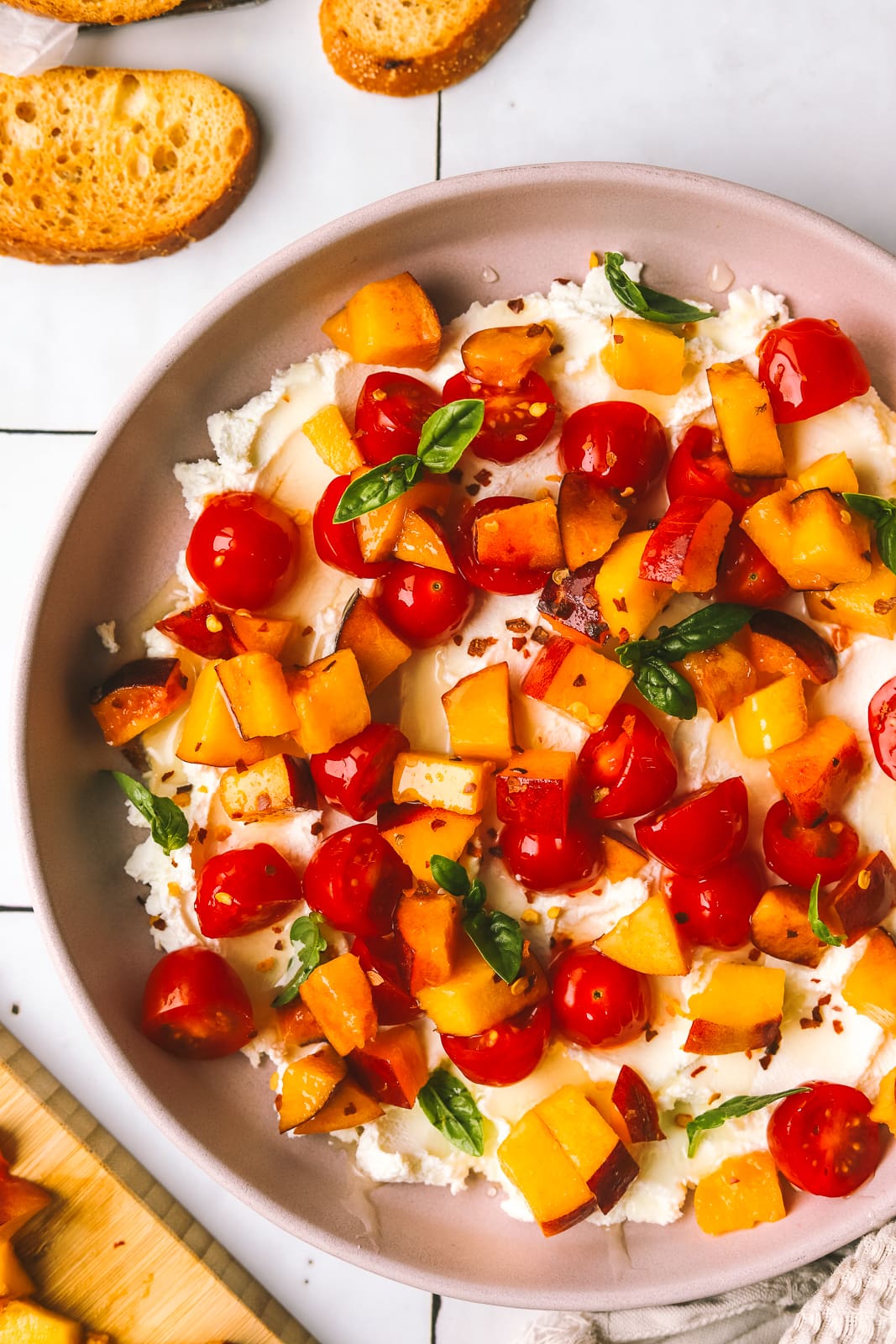 peaches and tomatoes with goat cheese served on crostini