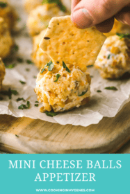 hand putting a cracker into a cheese ball