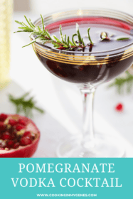 pomegranate cocktail in a coupe glass garnished with rosemary sprig