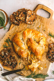 baked gruyere on a serving tray with crackers