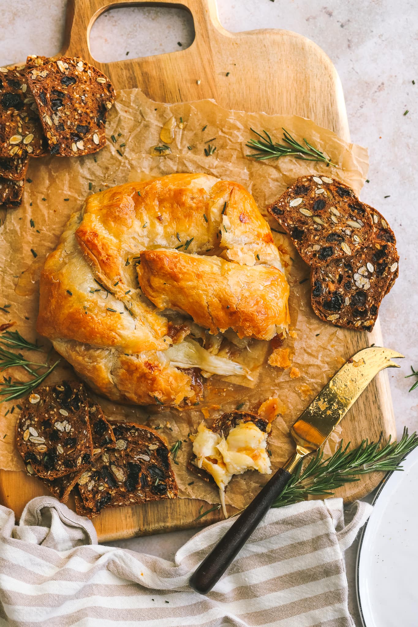baked gruyere on a serving tray with crackers