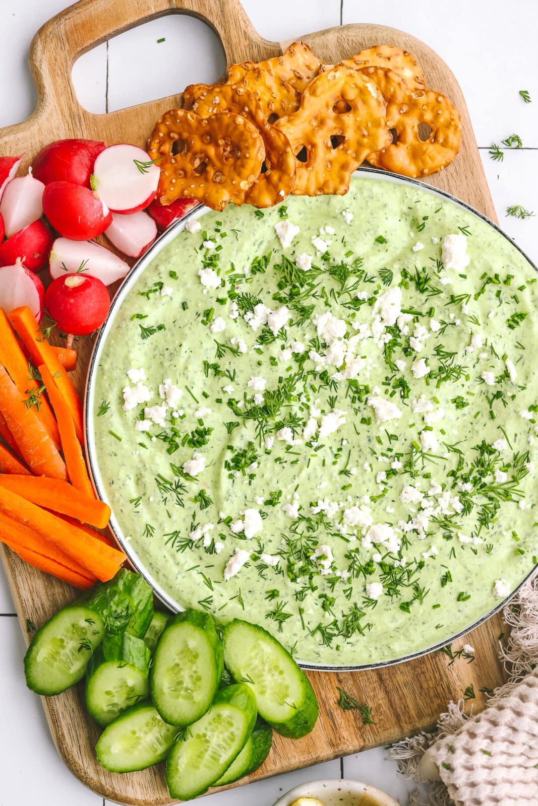 green goddess dip on a plate with vegetables and crackers