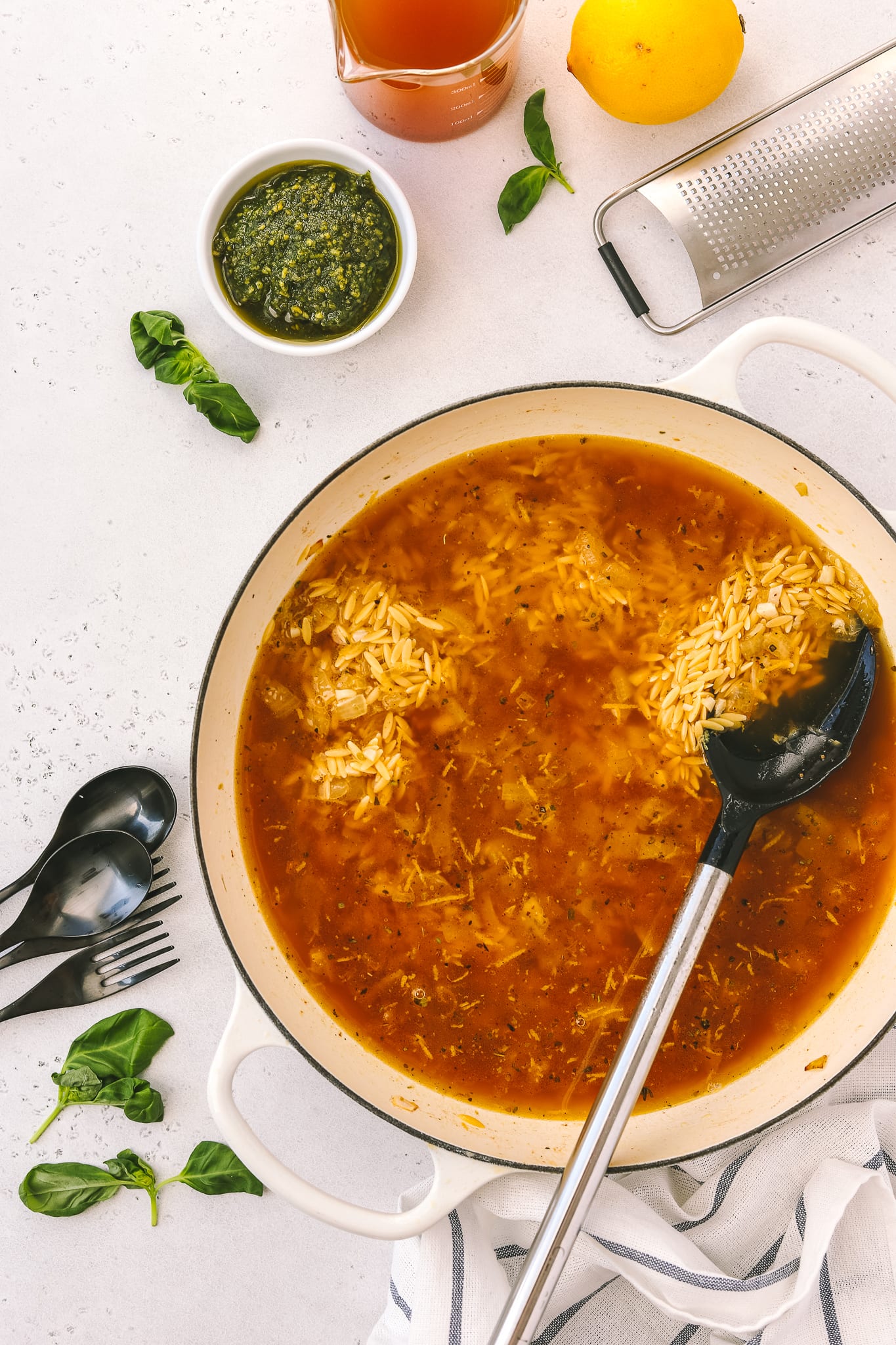 skillet with broth and orzo