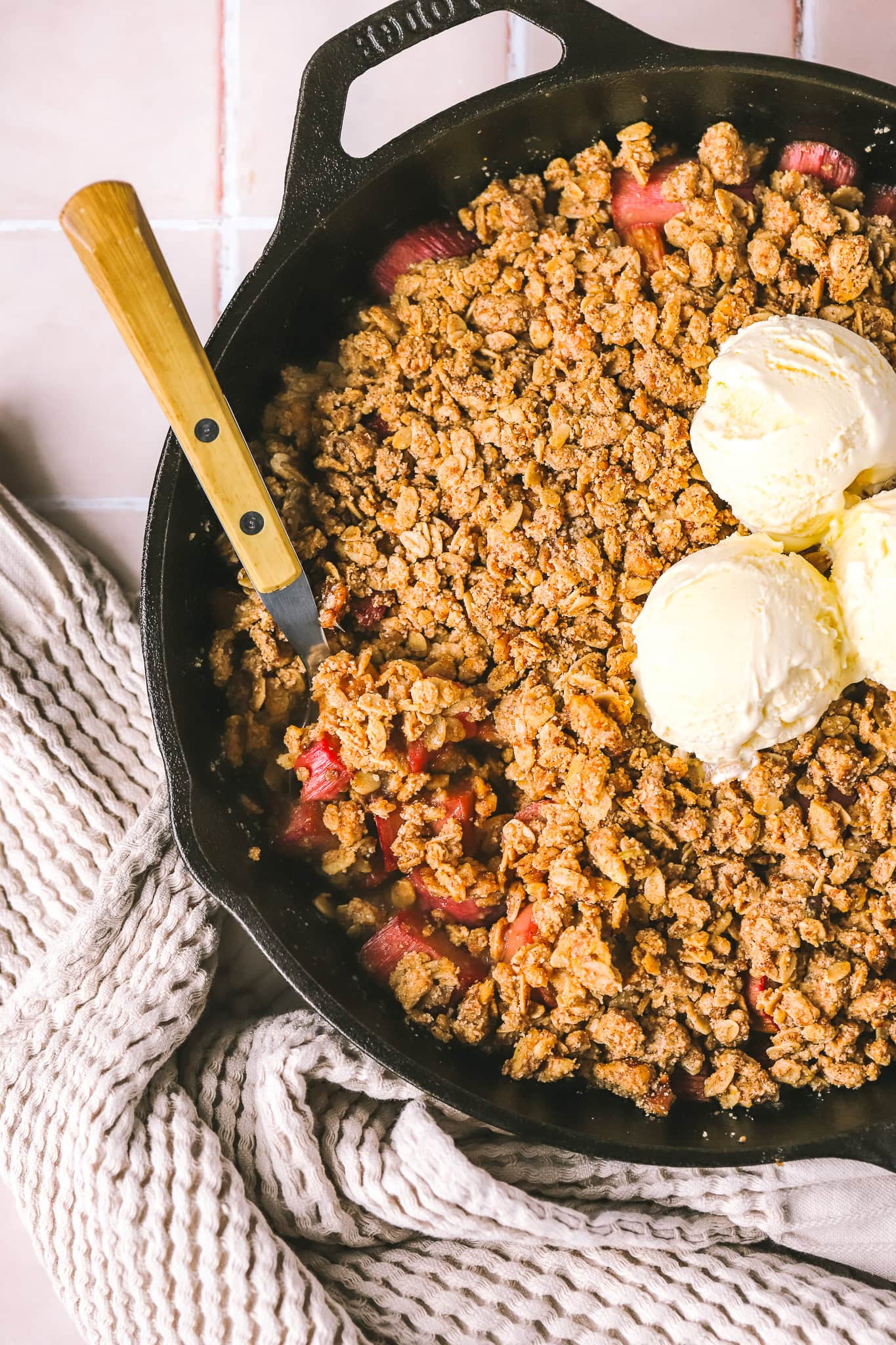 gluten free rhubarb crisp in a pan with ice cream