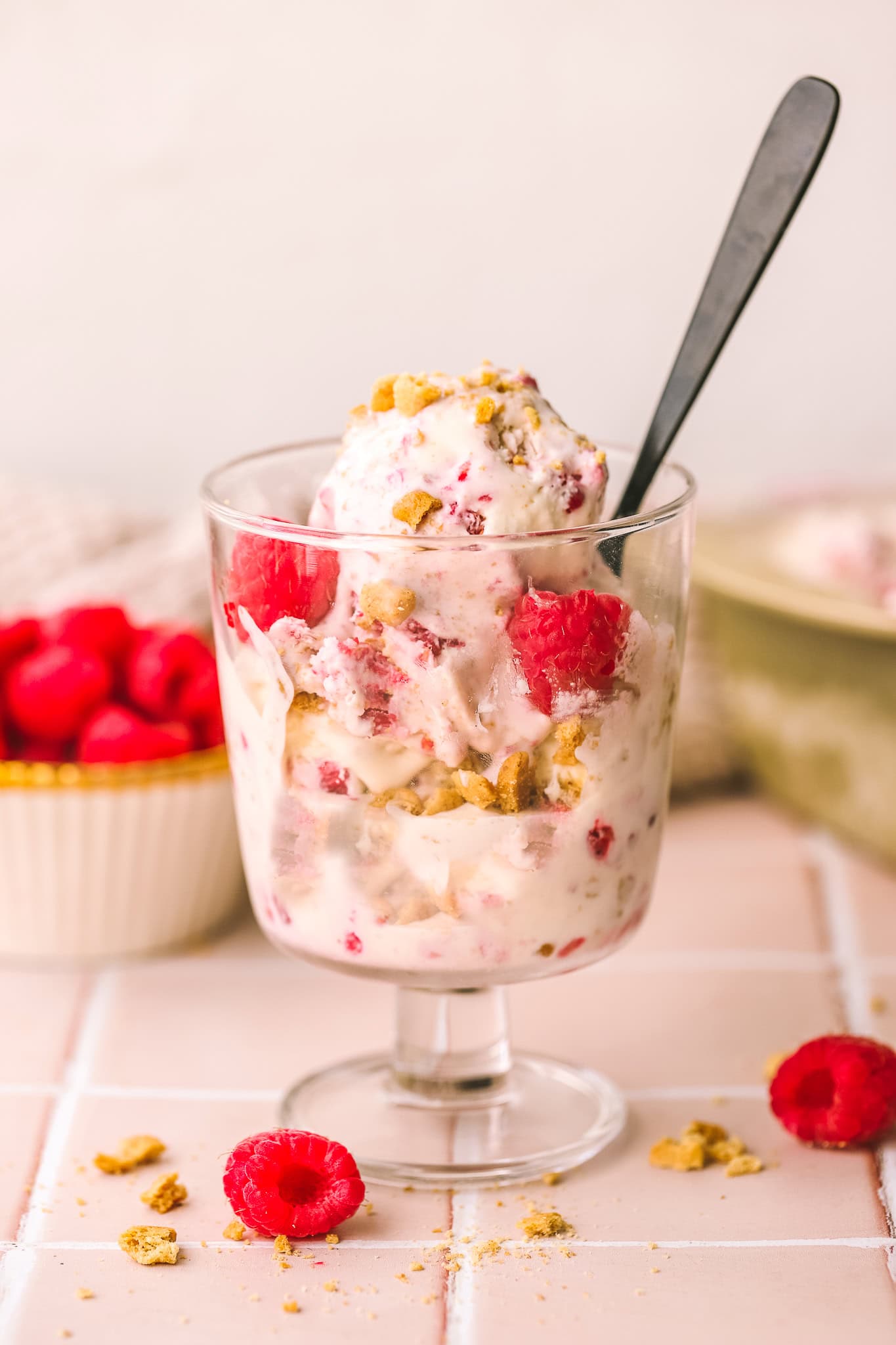 raspberry crumble ice cream in a cup with a spoon