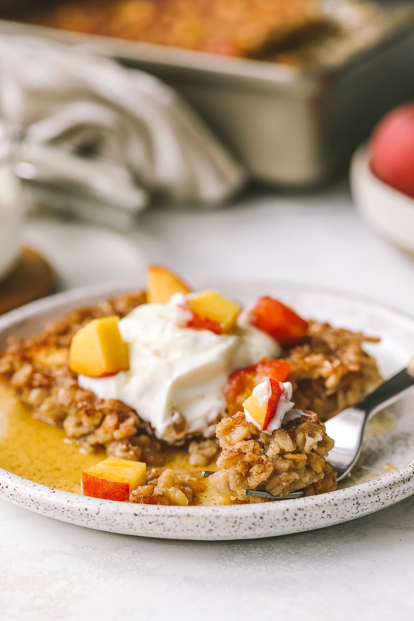 angled shot of peach baked oatmeal on a fork