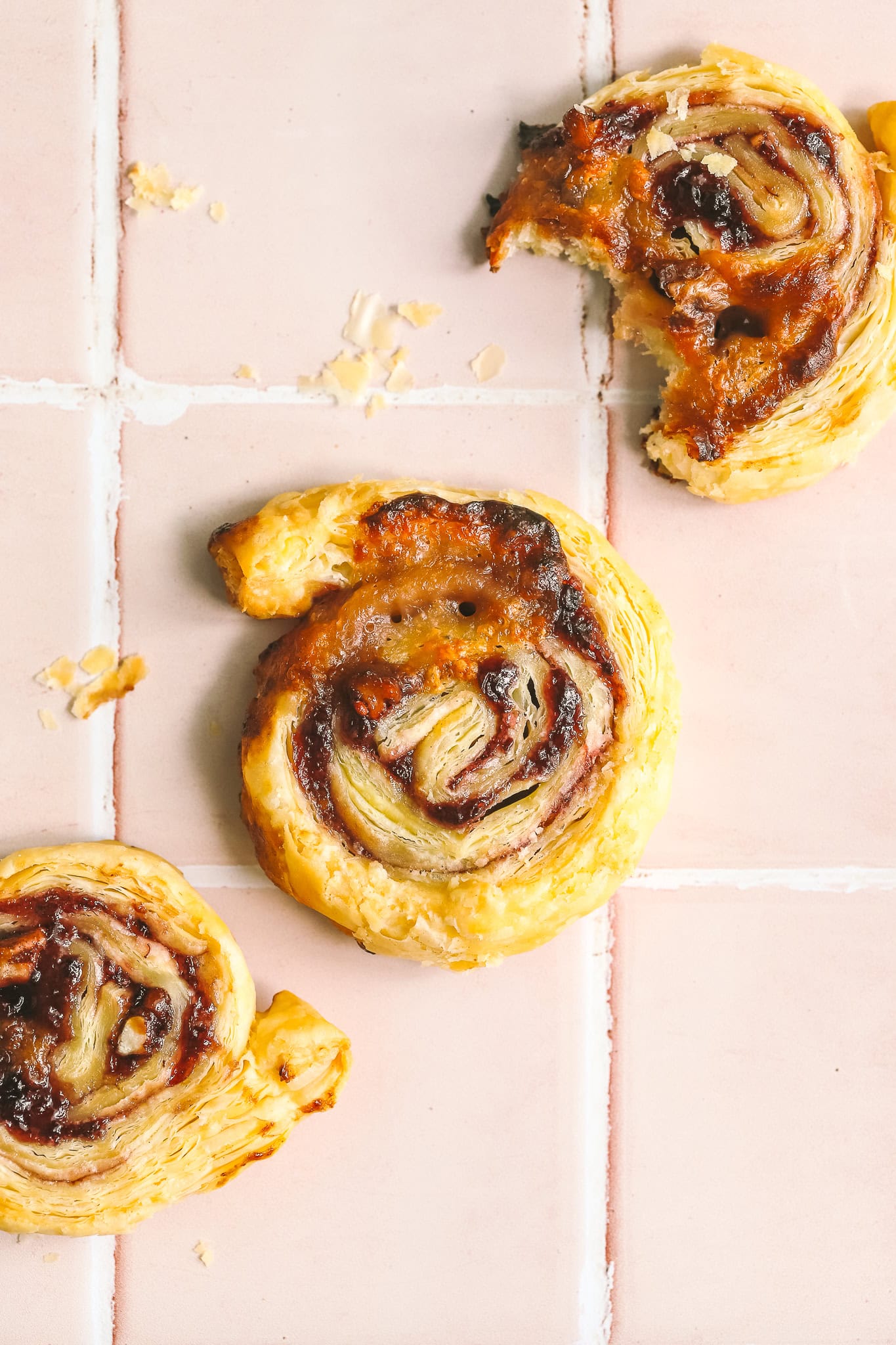 blackberry brie pinwheel on pink tile background