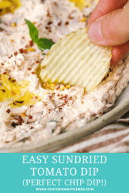 hand dipping a chip in dip