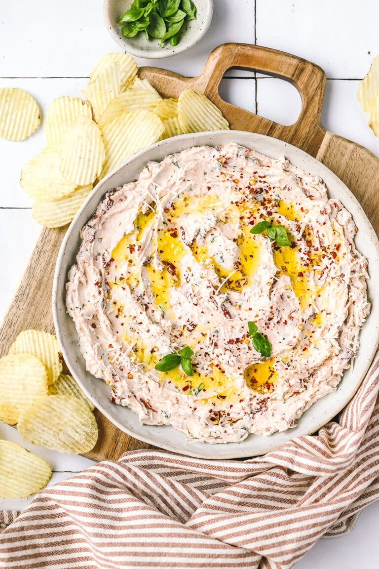 sundried tomato dip in a serving bowl with chips