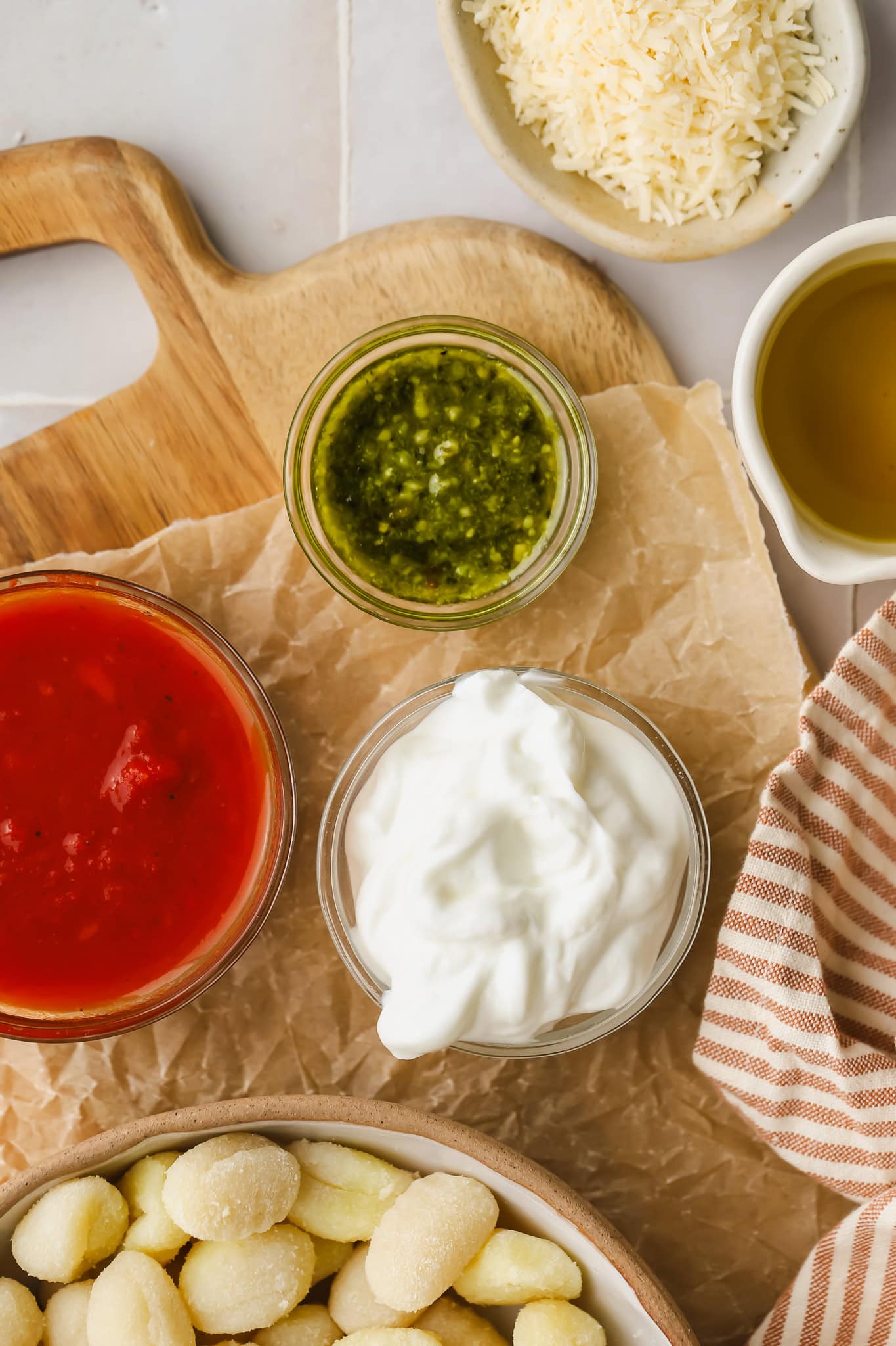 gnocchi, tomato sauce, pesto and greek yogurt in bowls