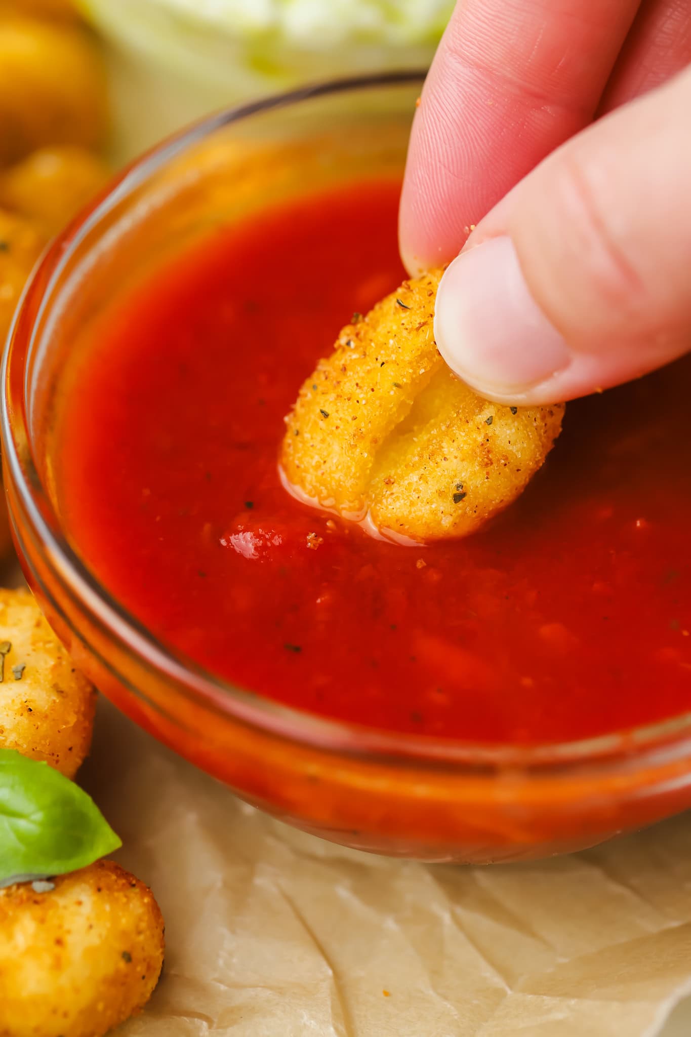 crispy gnocchi being dipped in tomato sauce