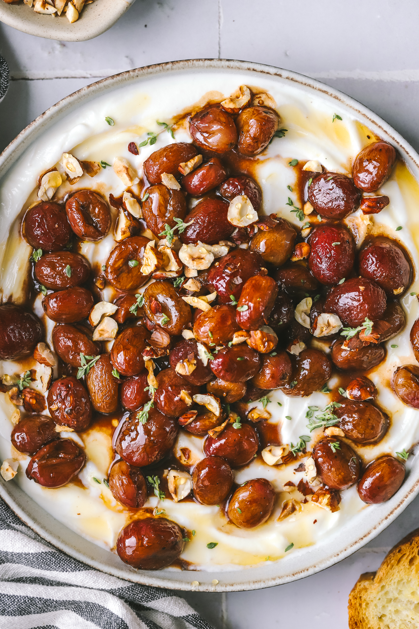 closeup of roasted grapes on whipped ricotta