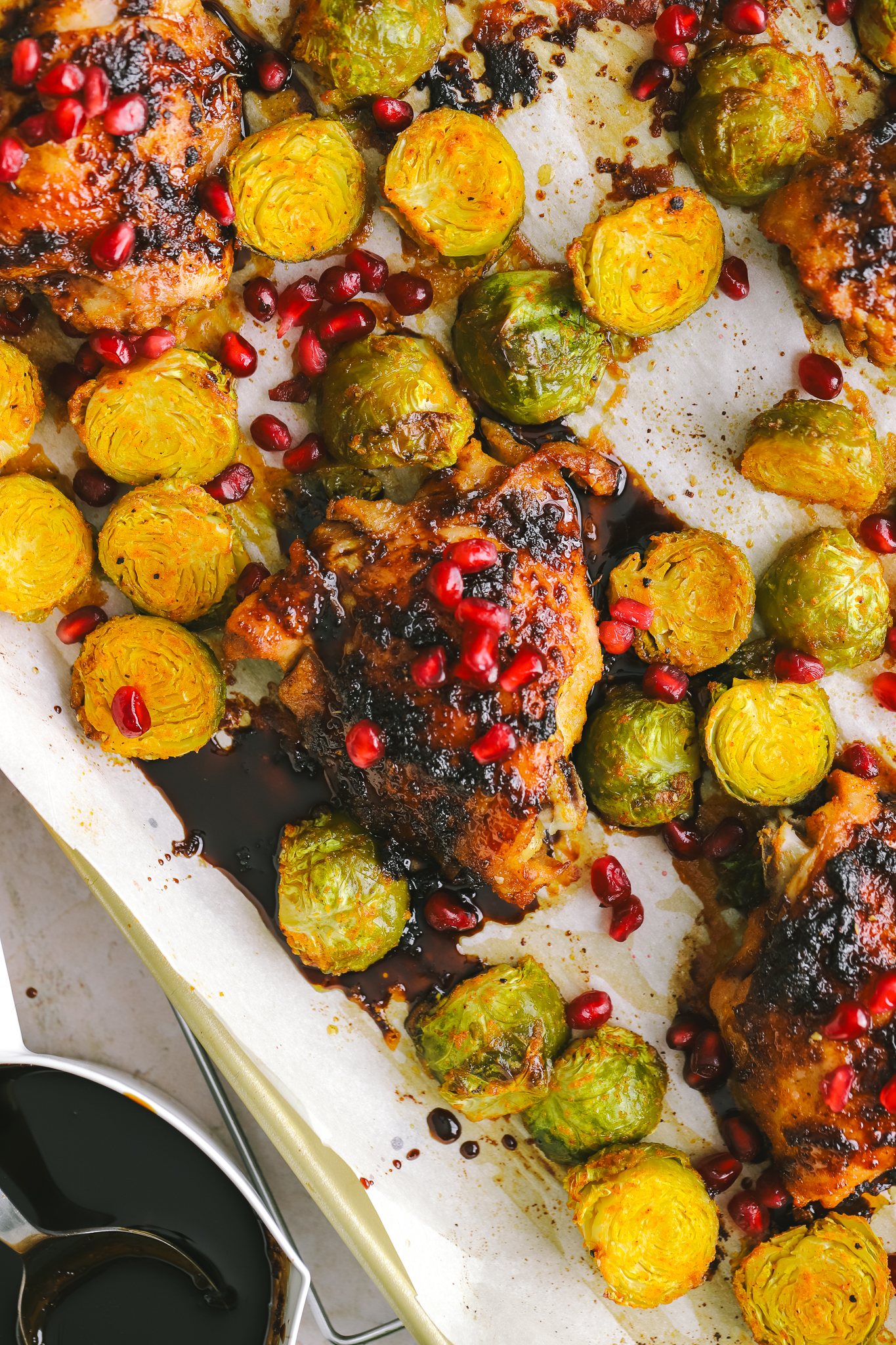 pomegranate chicken dinner on a sheet pan