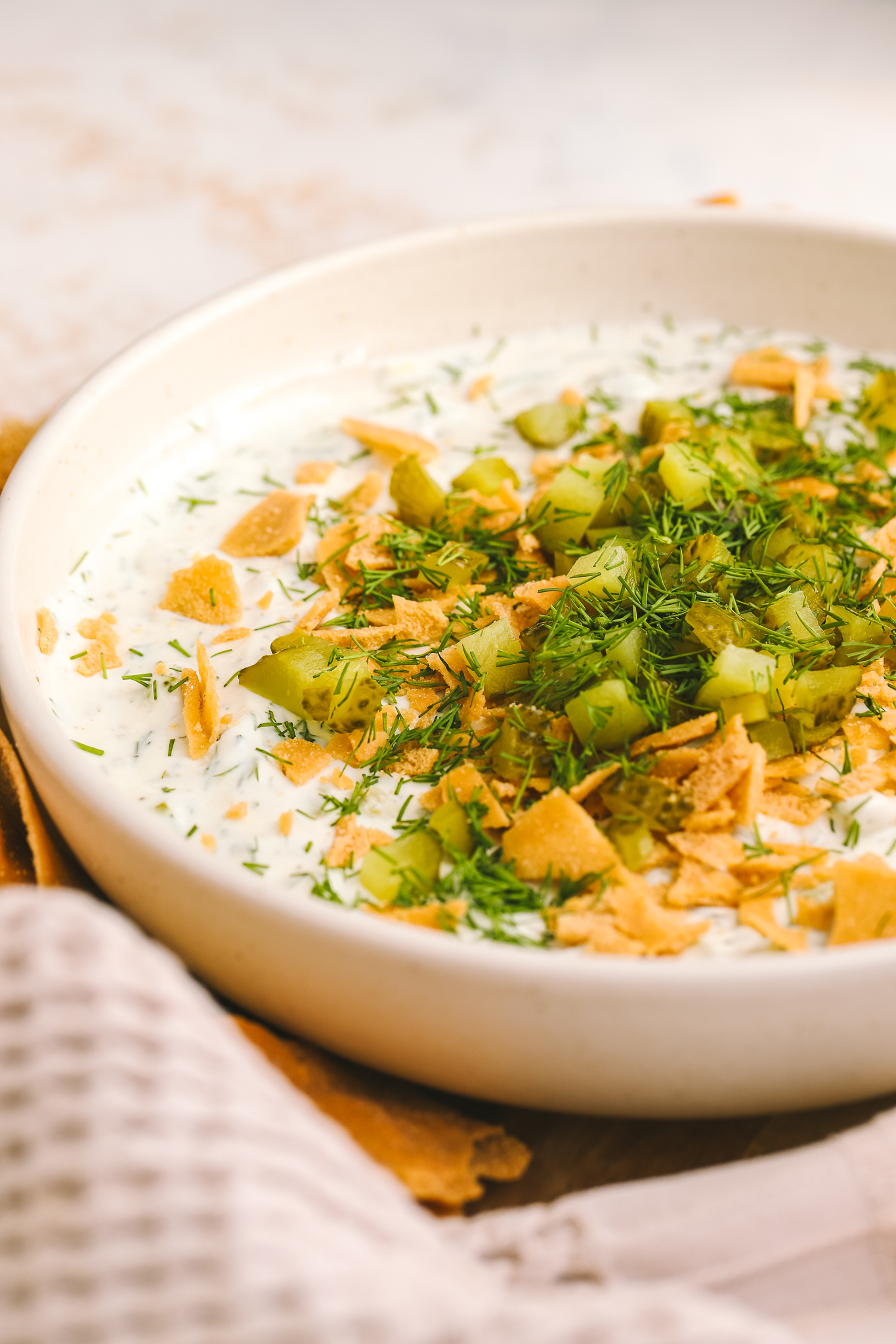 side angle high protein dill pickle dip in a bowl 