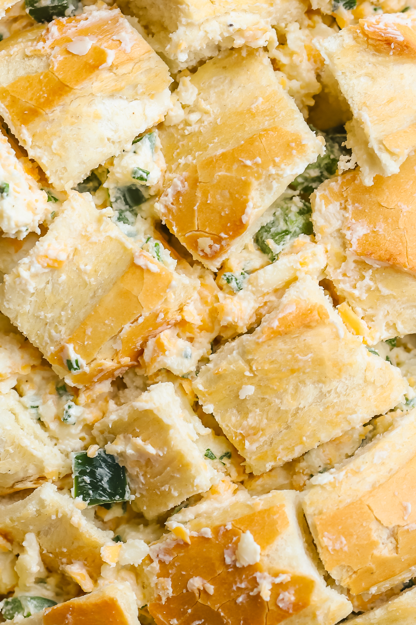 close up of bread filled with cheese and jalapenos