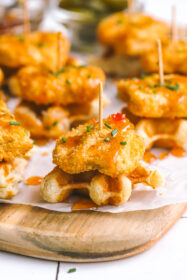 mini chicken & waffles appetizer with hot honey on a serving board