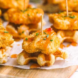 mini chicken & waffles appetizer with hot honey on a serving board
