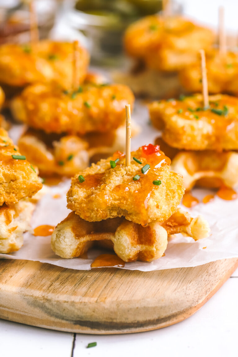 mini chicken & waffles appetizer with hot honey on a serving board