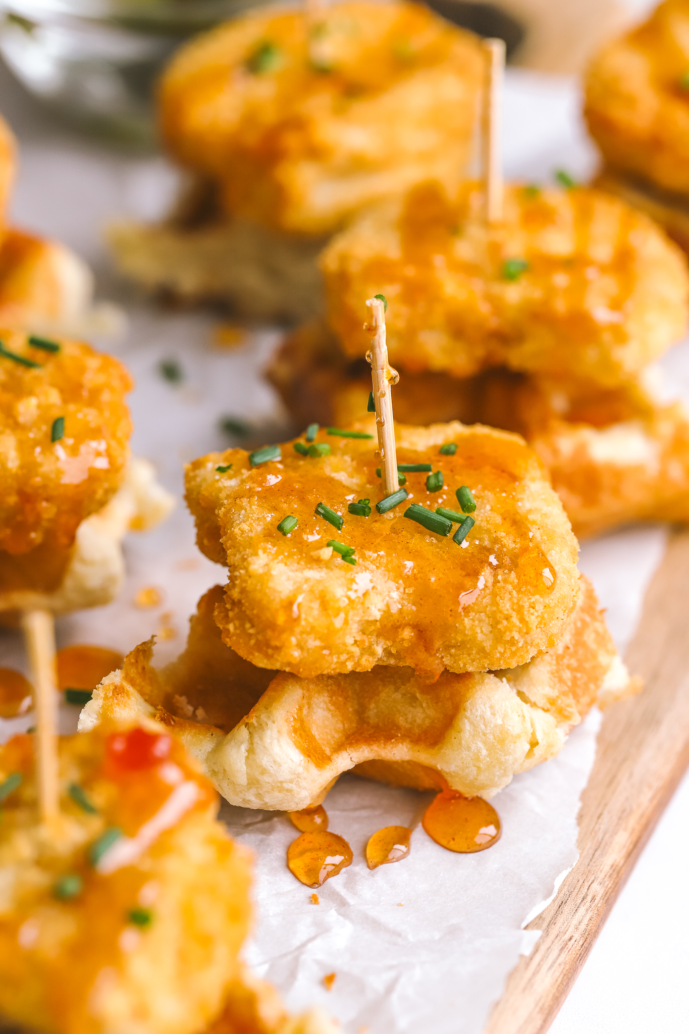 mini chicken & waffles appetizer with hot honey on a serving board