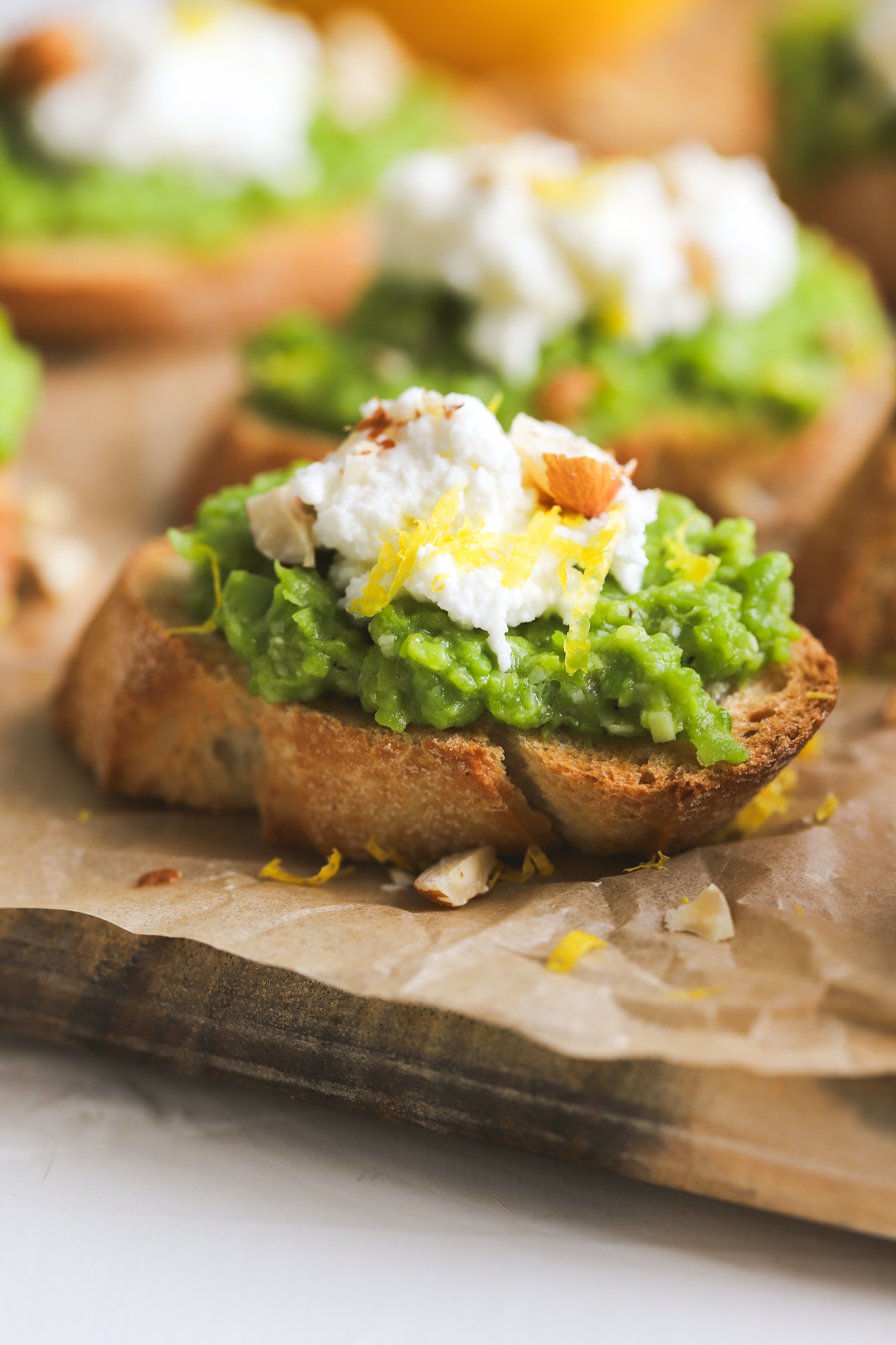 crostini with smashed green peas, ricotta and hazelnuts