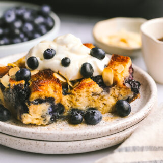 a piece of blueberry breakfast bake topped with maple cream cheese topping