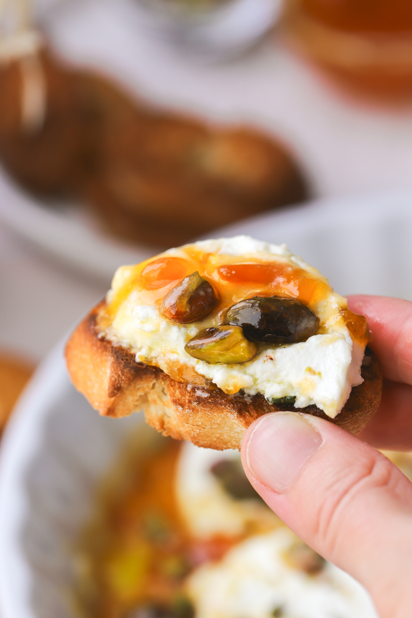 baked goat cheese with apricot jam and pistachios on crostini
