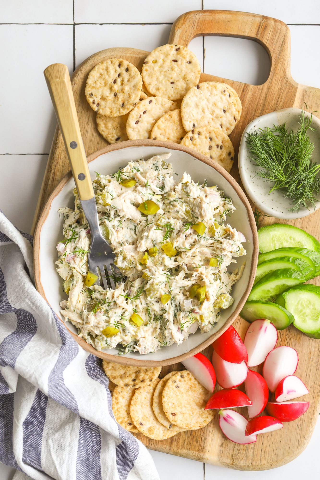 dill pickle chicken salad on a sharing board with crackers and vegetables