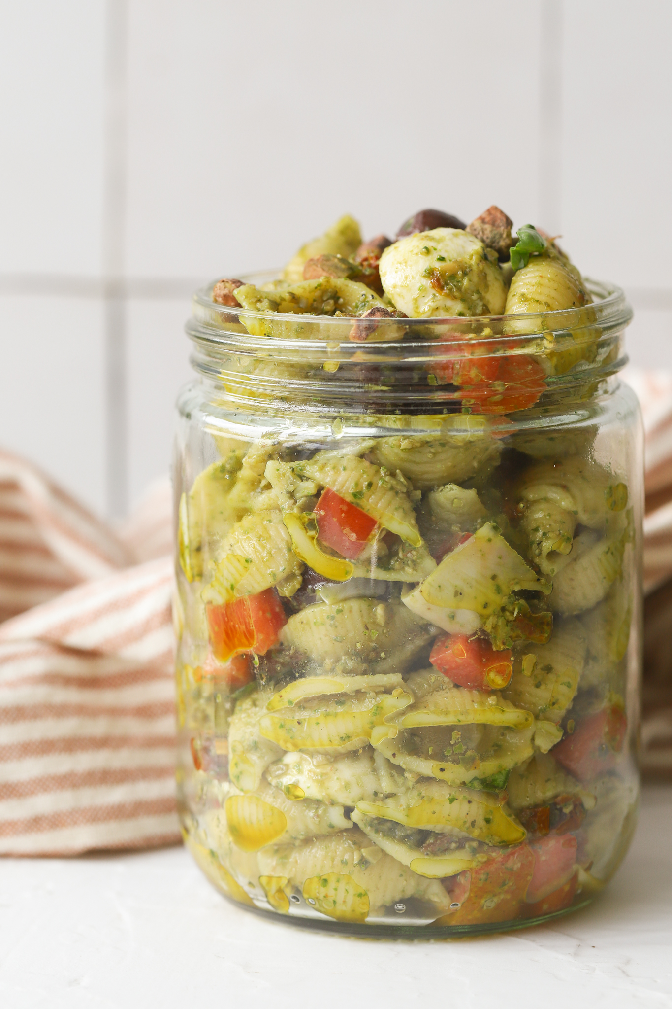 mason jar full of pesto pasta salad