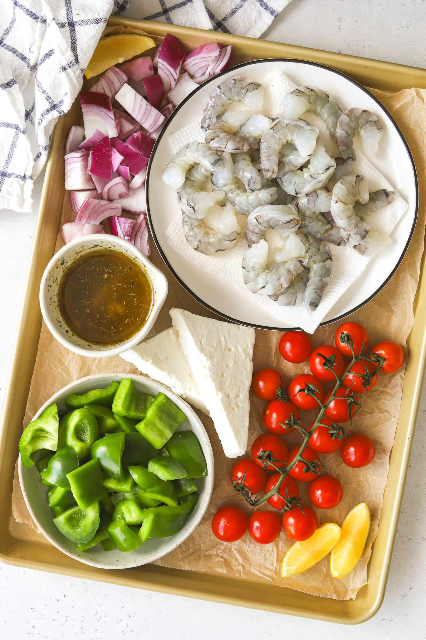 ingredients in bowls to make a shrimp sheet pan dinner