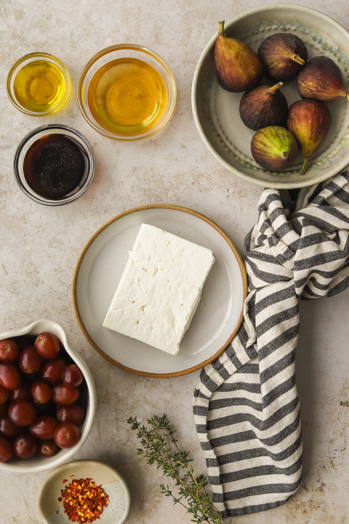 feta, grapes, chili flakes, honey and figs in dishes