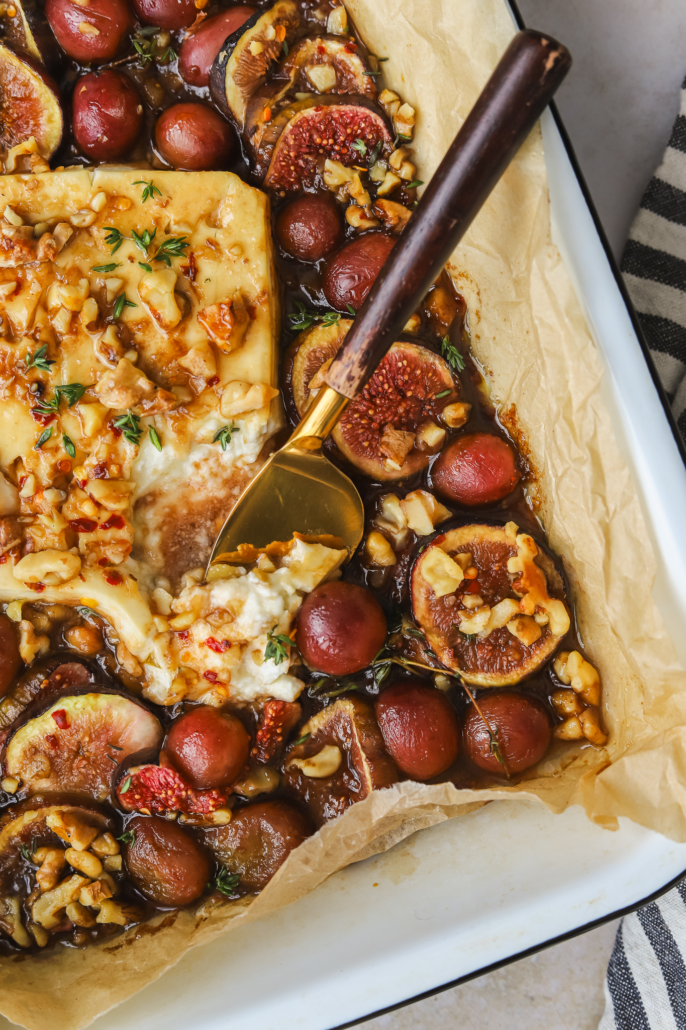 serving knife slicing baked feta