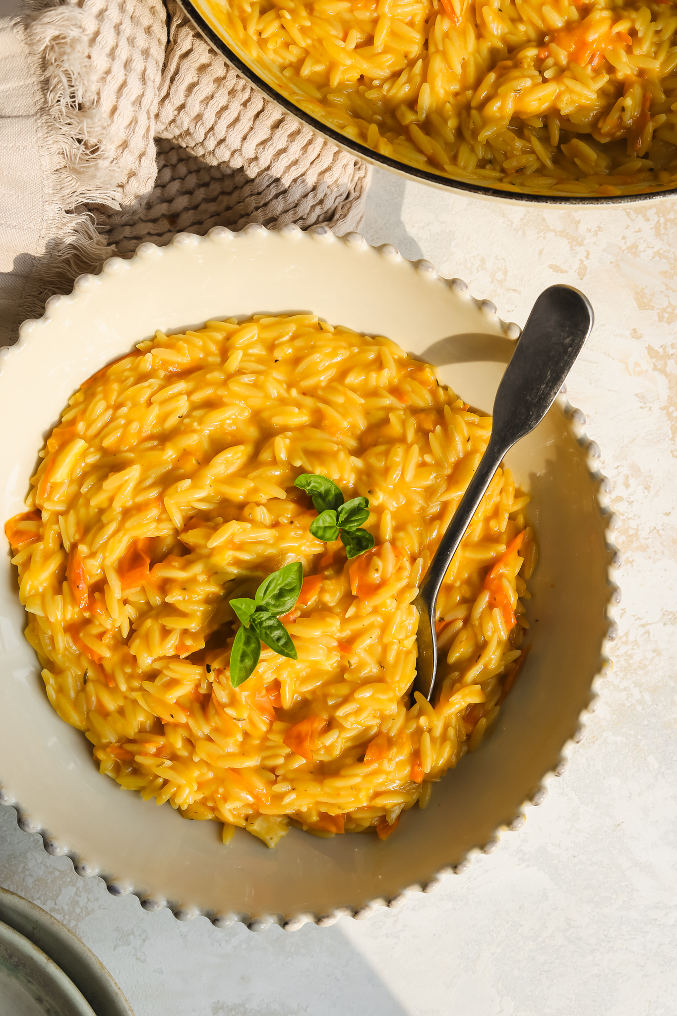 sungold tomato orzo pasta in a bowl with a spoon