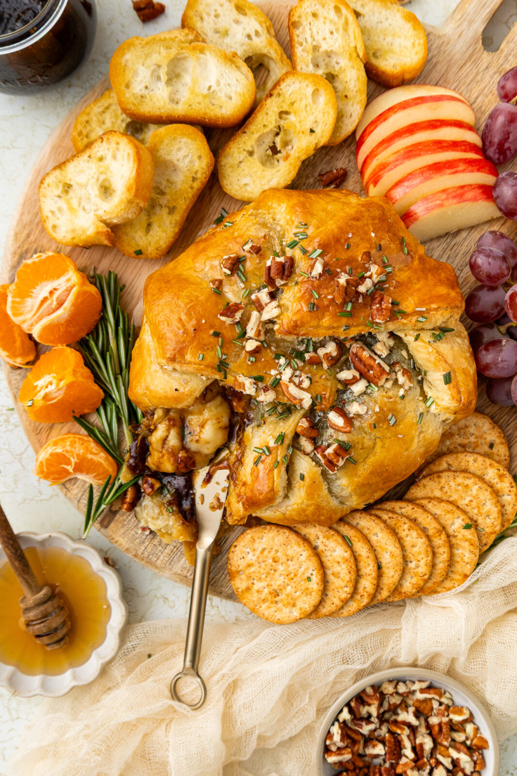 baked brie with fig jam on a cheese board