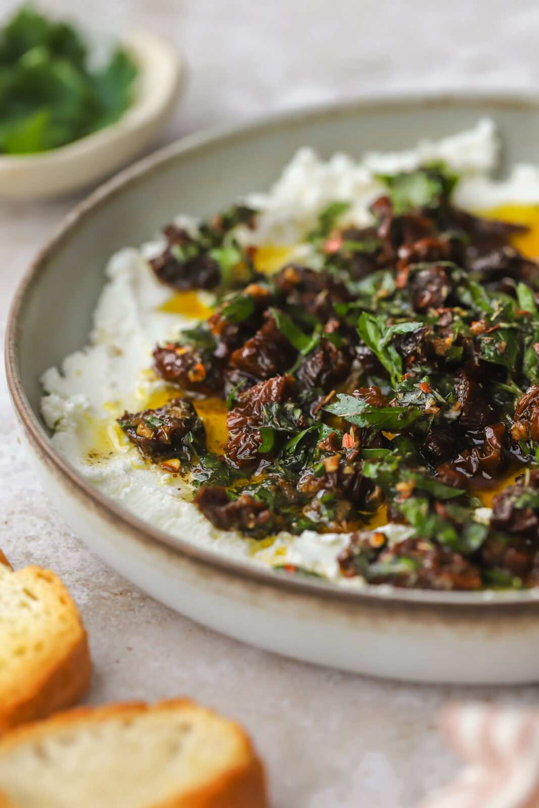 angled photo of marinated goat cheese dip
