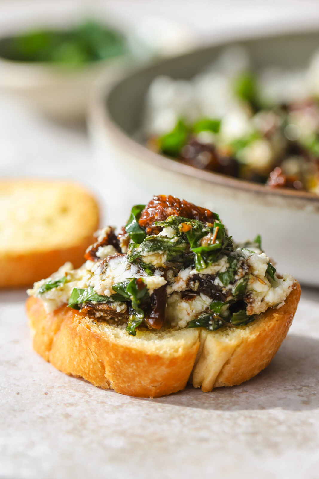 crostini topped with goat cheese, sundried tomatoes and fresh herbs