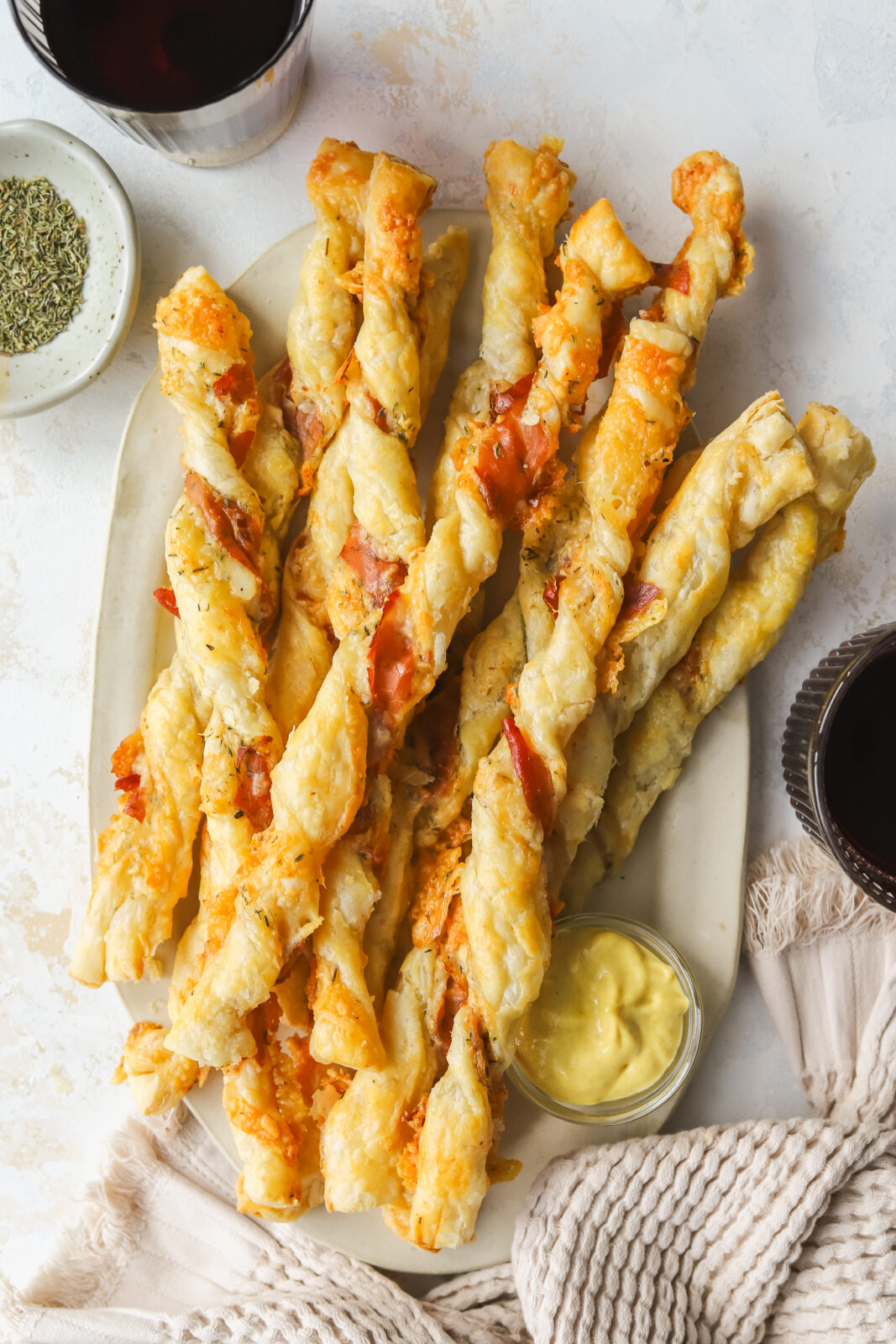 cheese twists on a serving platter with mustard