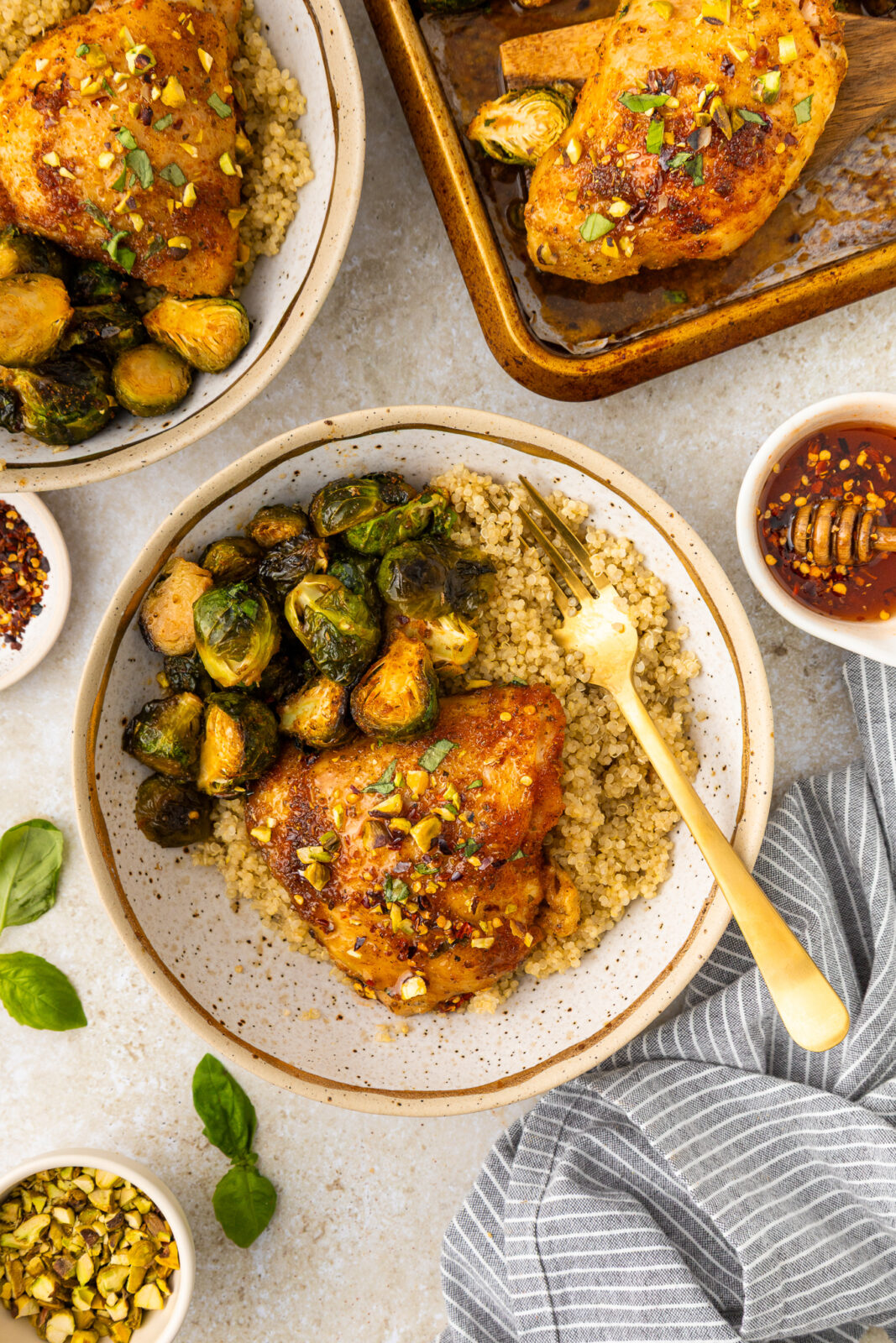 hot honey chicken on quinoa with brussels sprouts in a bowl