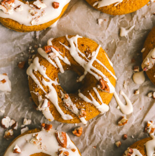 close up of pumpkin donut with maple icing