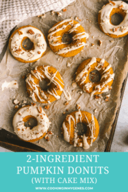 iced pumpkin donuts on a baking sheet