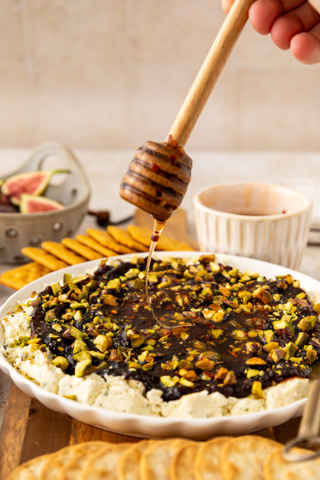 hot honey drizzling overtop of boursin fig appetizer