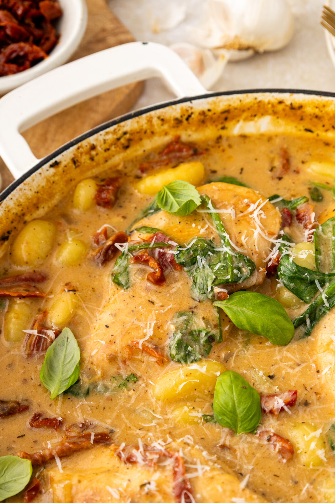 marry me chicken and gnocchi in a pan with fresh basil