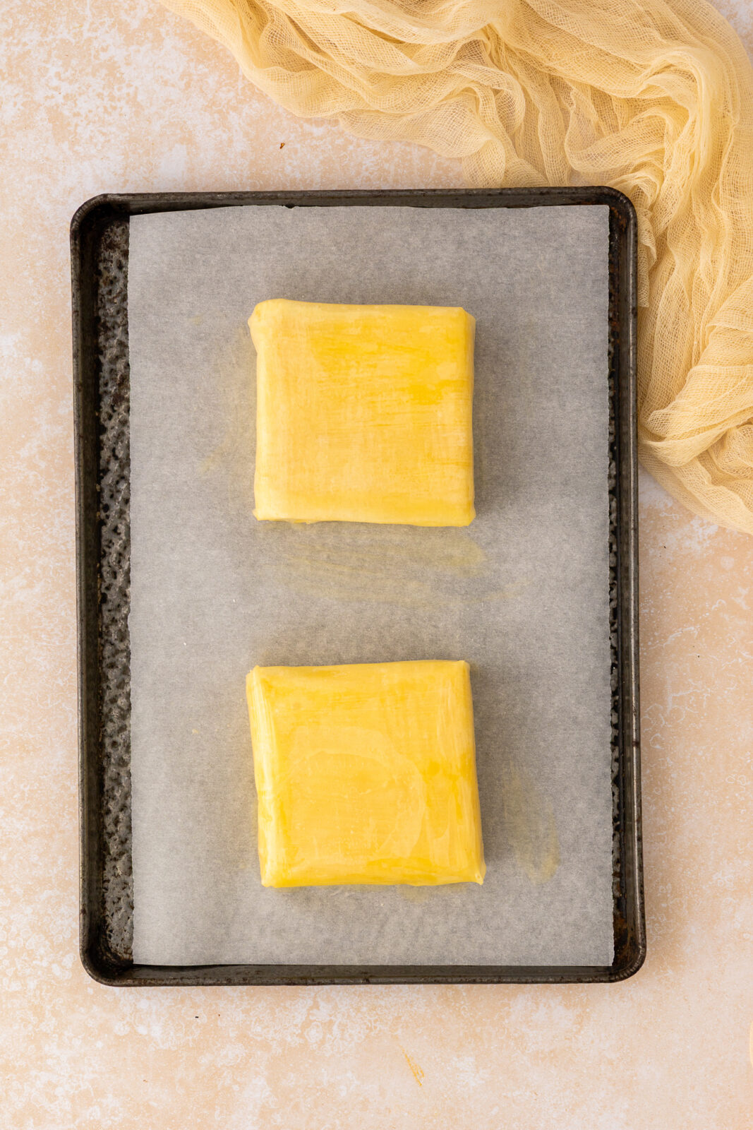 feta wrapped with phyllo dough on a baking sheet