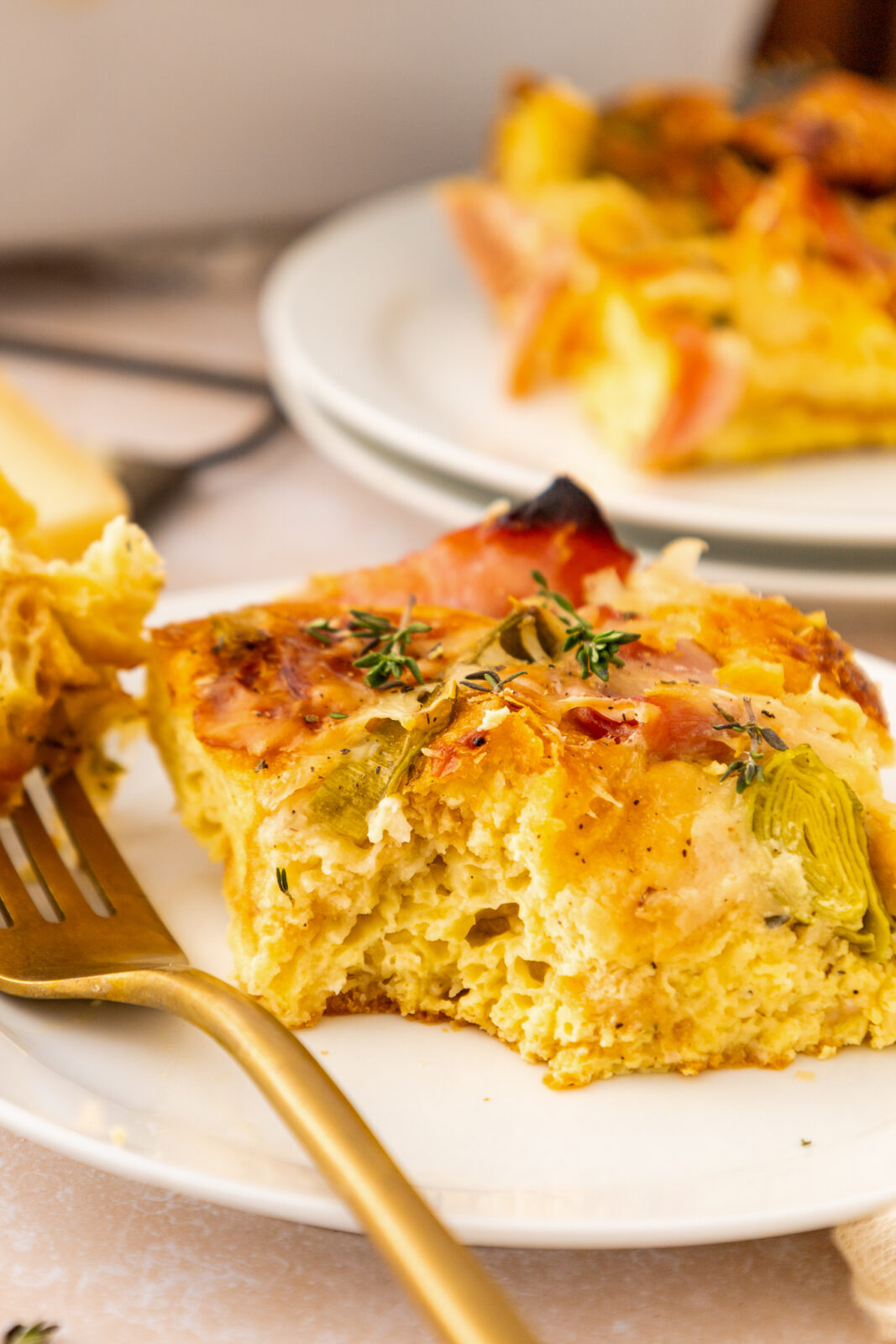 piece of ham and cheese breakfast casserole on a plate