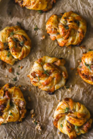 fully baked cranberry goat cheese puff pastry swirls on a baking sheet