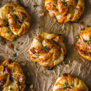 fully baked cranberry goat cheese puff pastry swirls on a baking sheet