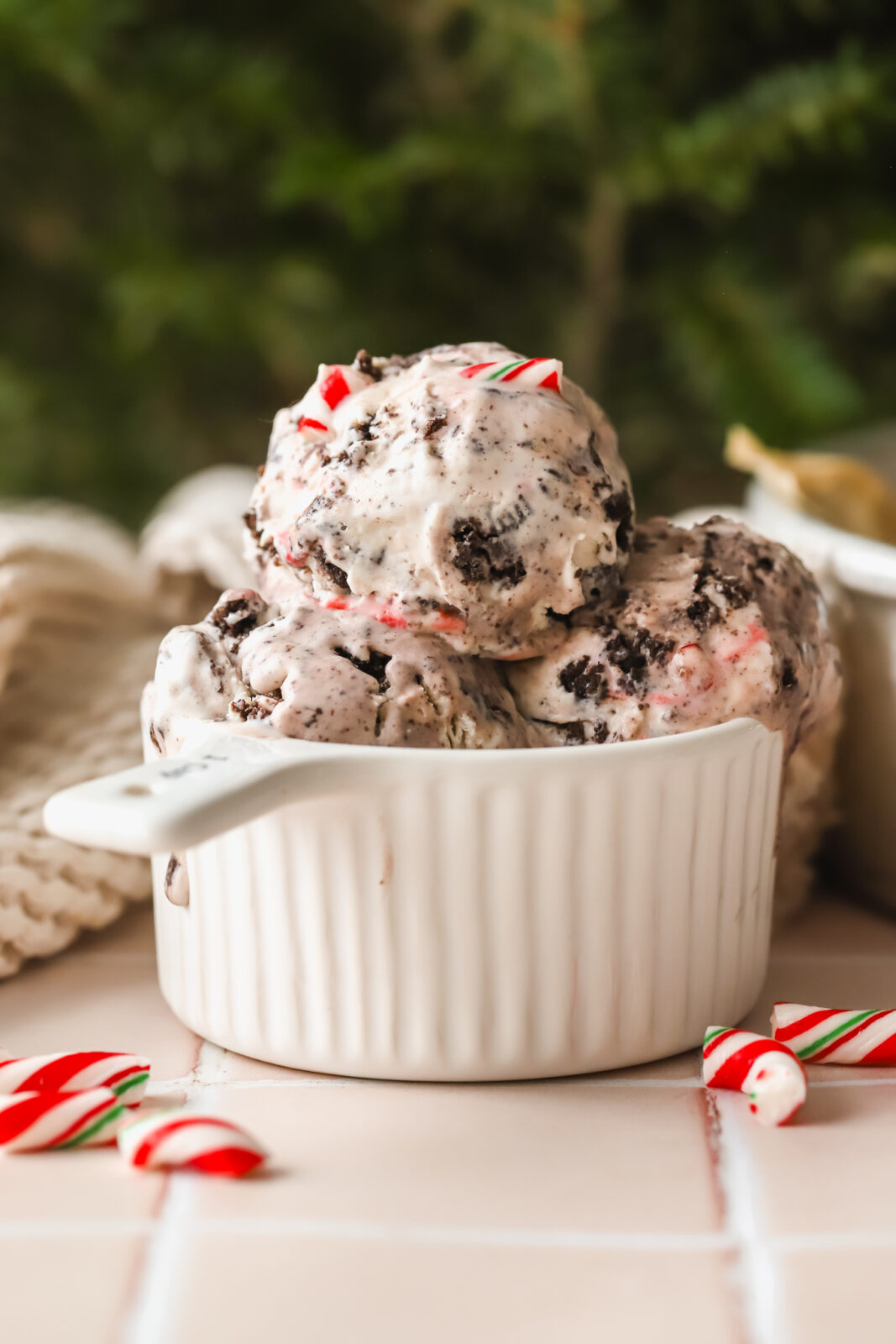 scoops of no churn ice cream with candy canes and Oreos in a dish